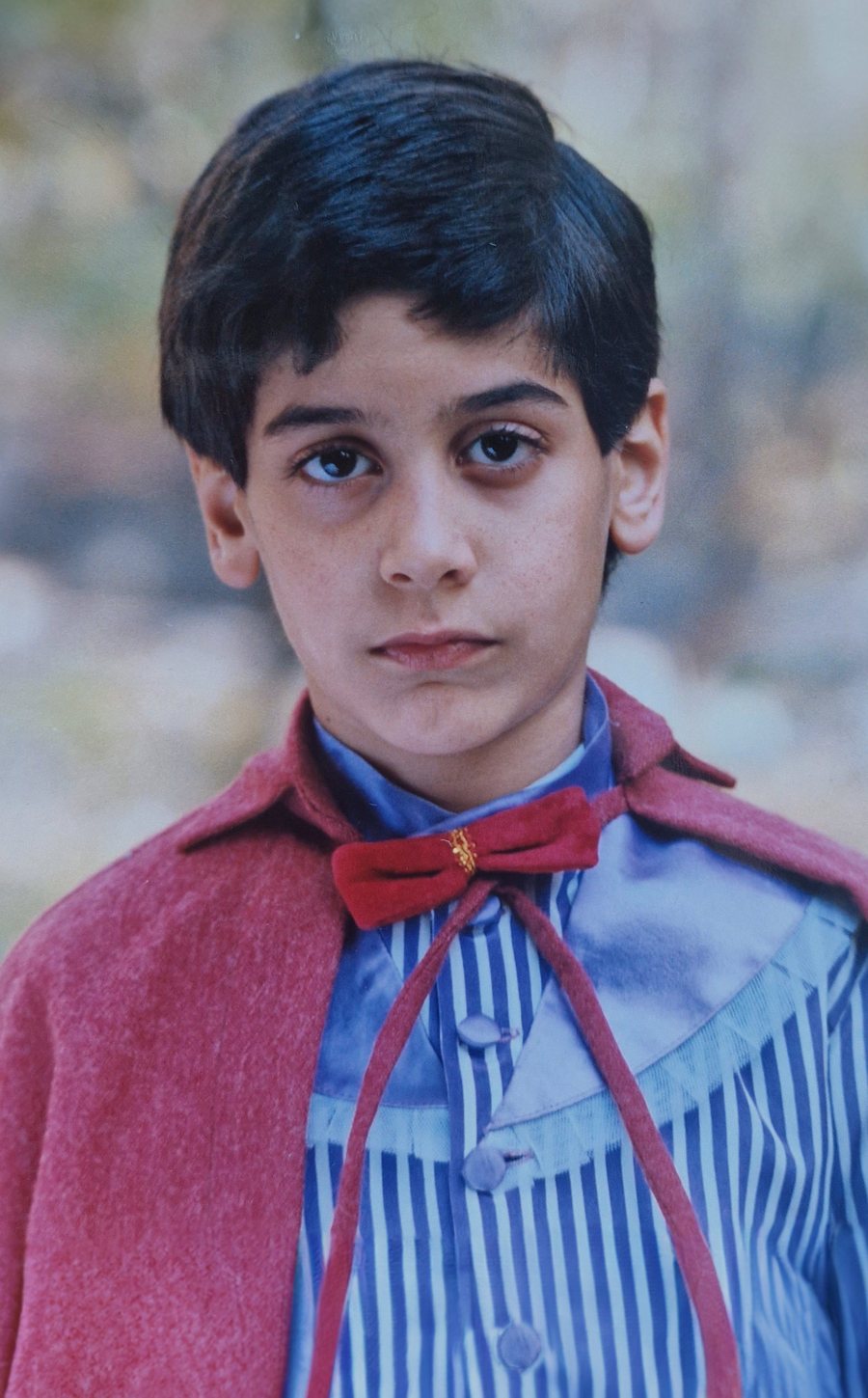 Mani Nickpour as a child, in costume on a film set