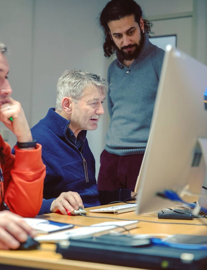 Mani helping a student with editing software